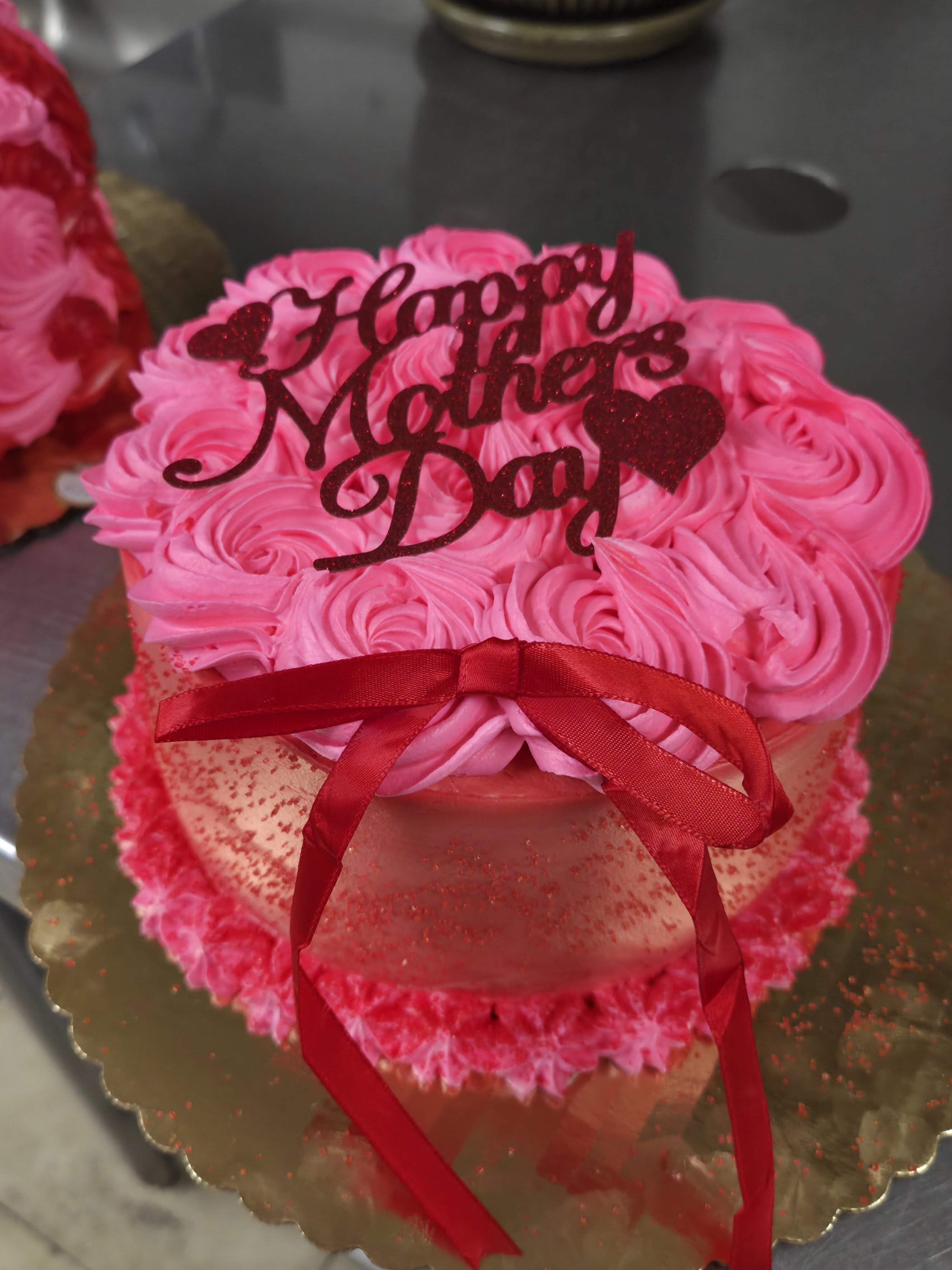 Pink Mother's Day cake with a ribbon