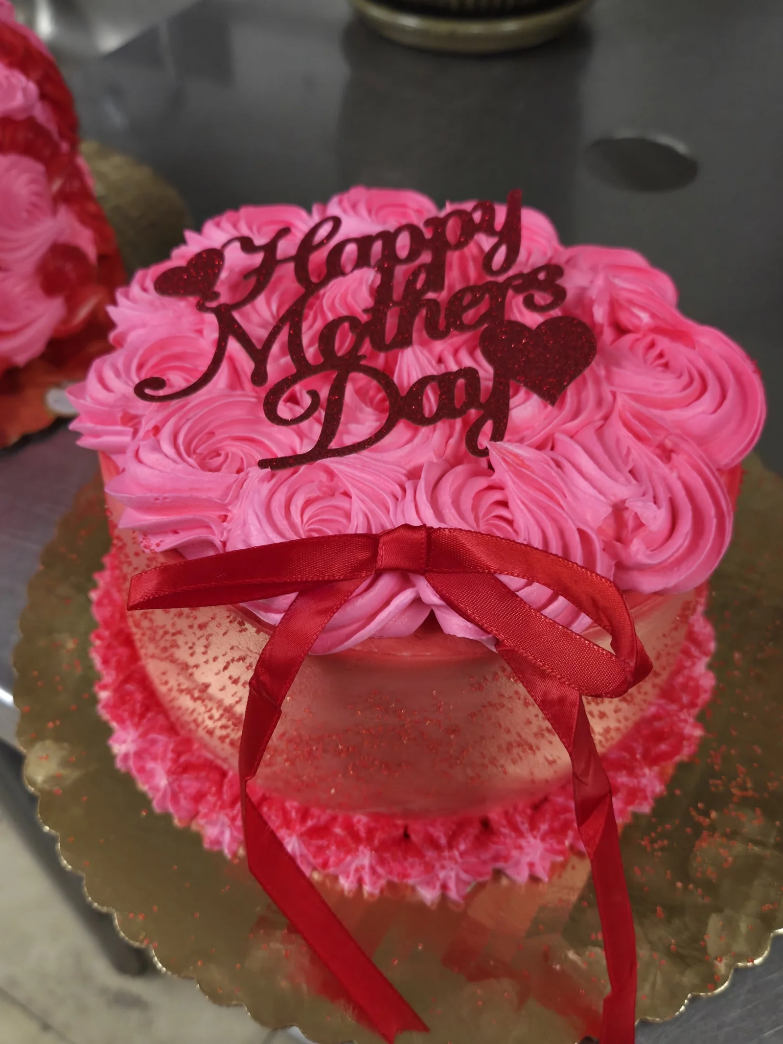 Pink Mother's Day cake with a ribbon